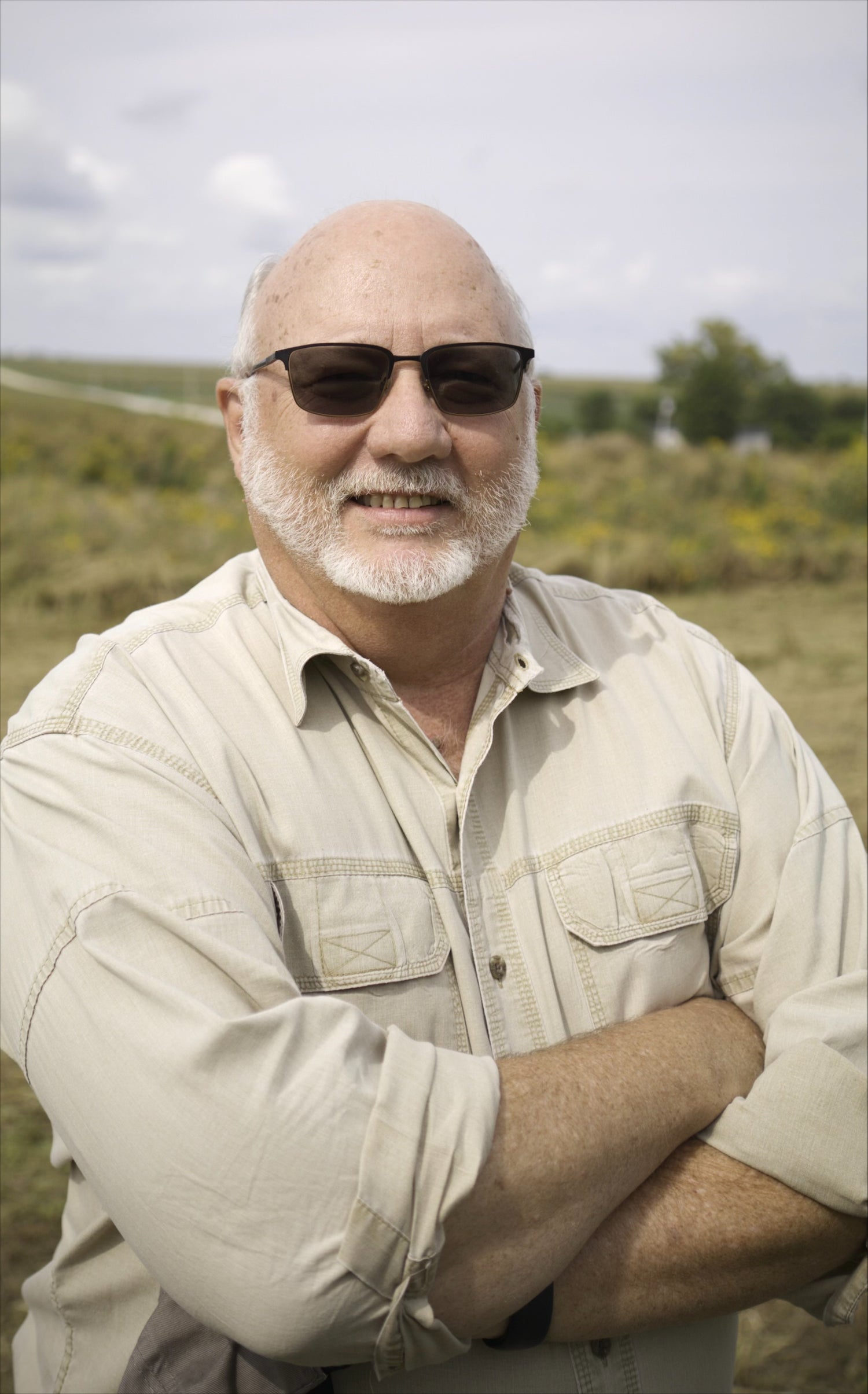 A profile photo of Steve Mowry smiling while standing outside with grass and trees in the background.